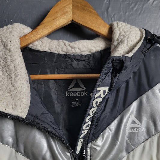 Reebok Black and white with Glacier Shield insulation. 2 zippered pockets and a Sherpa-like lined hood (Unisex)