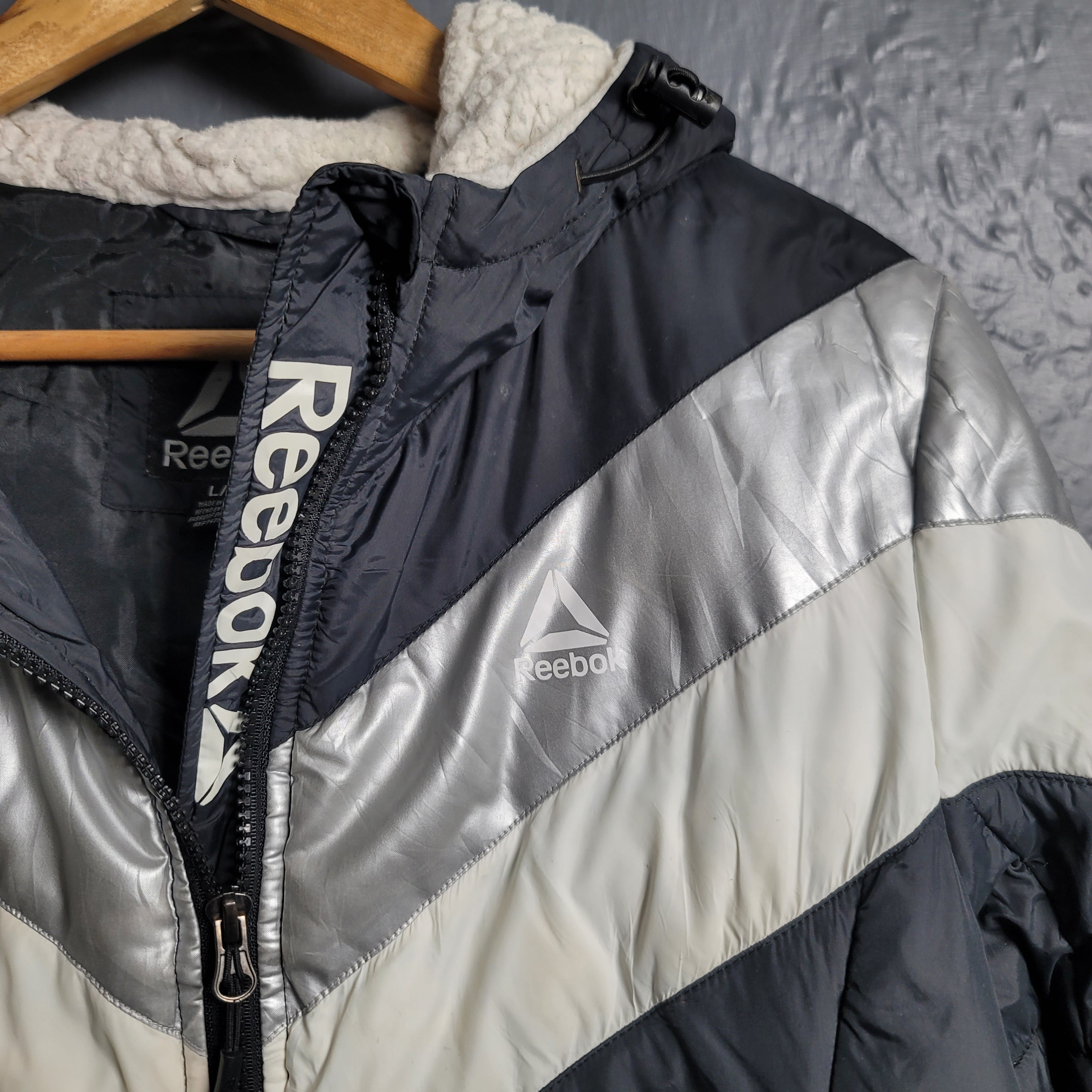 Reebok Black and white with Glacier Shield insulation. 2 zippered pockets and a Sherpa-like lined hood (Unisex)