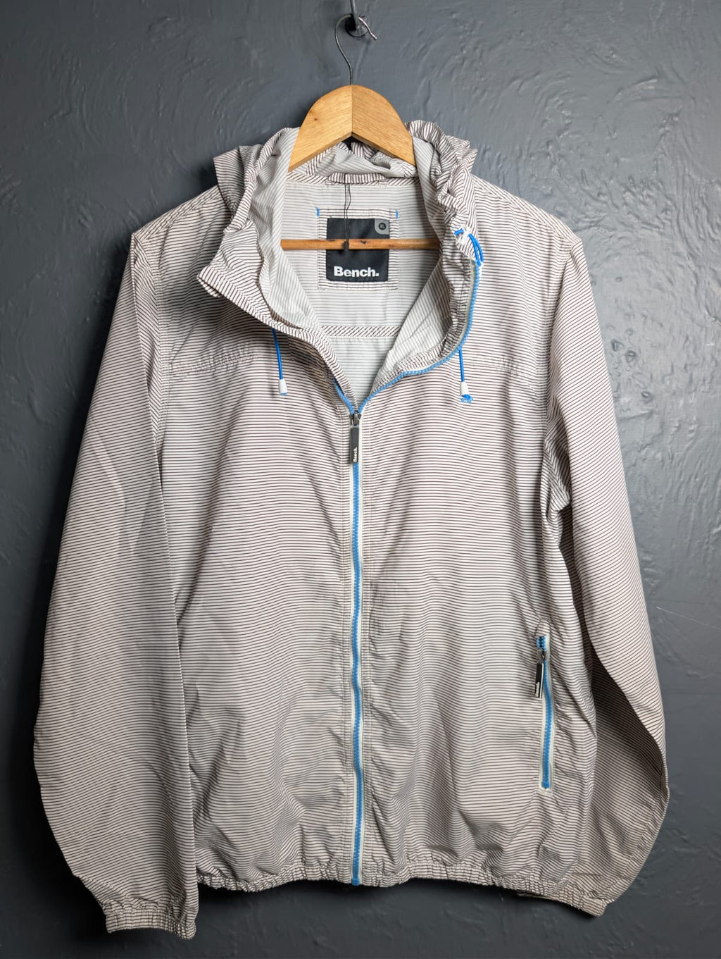Men's Bench lightweight hooded windbreaker jacket with blue accents.