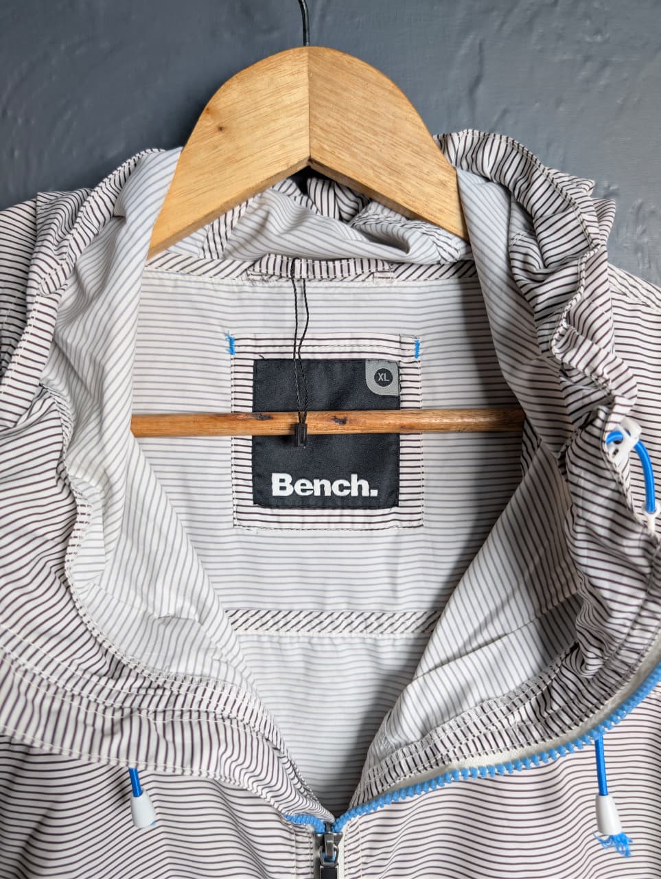 Men's Bench lightweight hooded windbreaker jacket with blue accents.