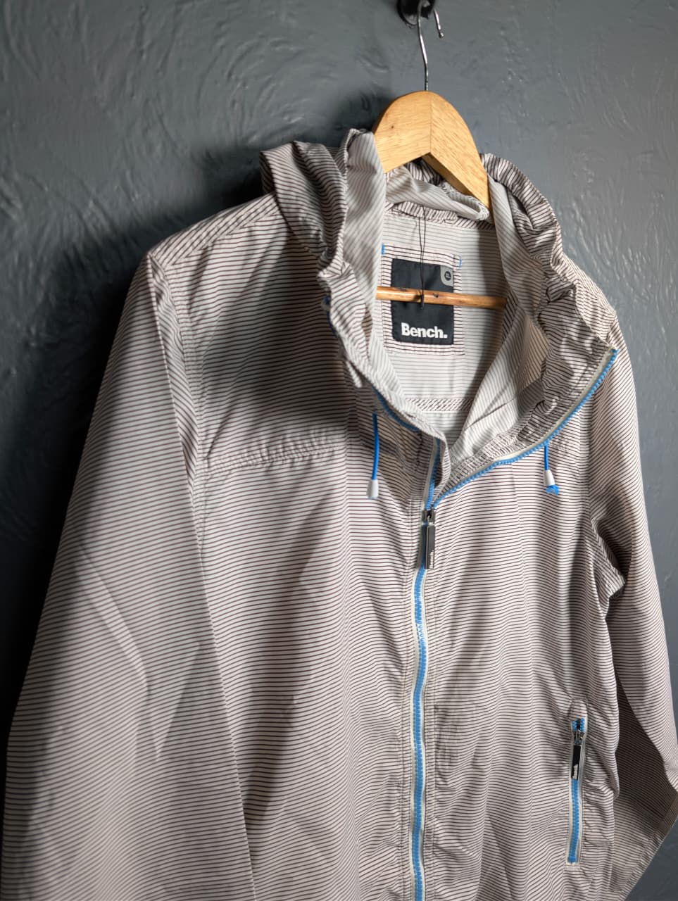 Men's Bench lightweight hooded windbreaker jacket with blue accents.