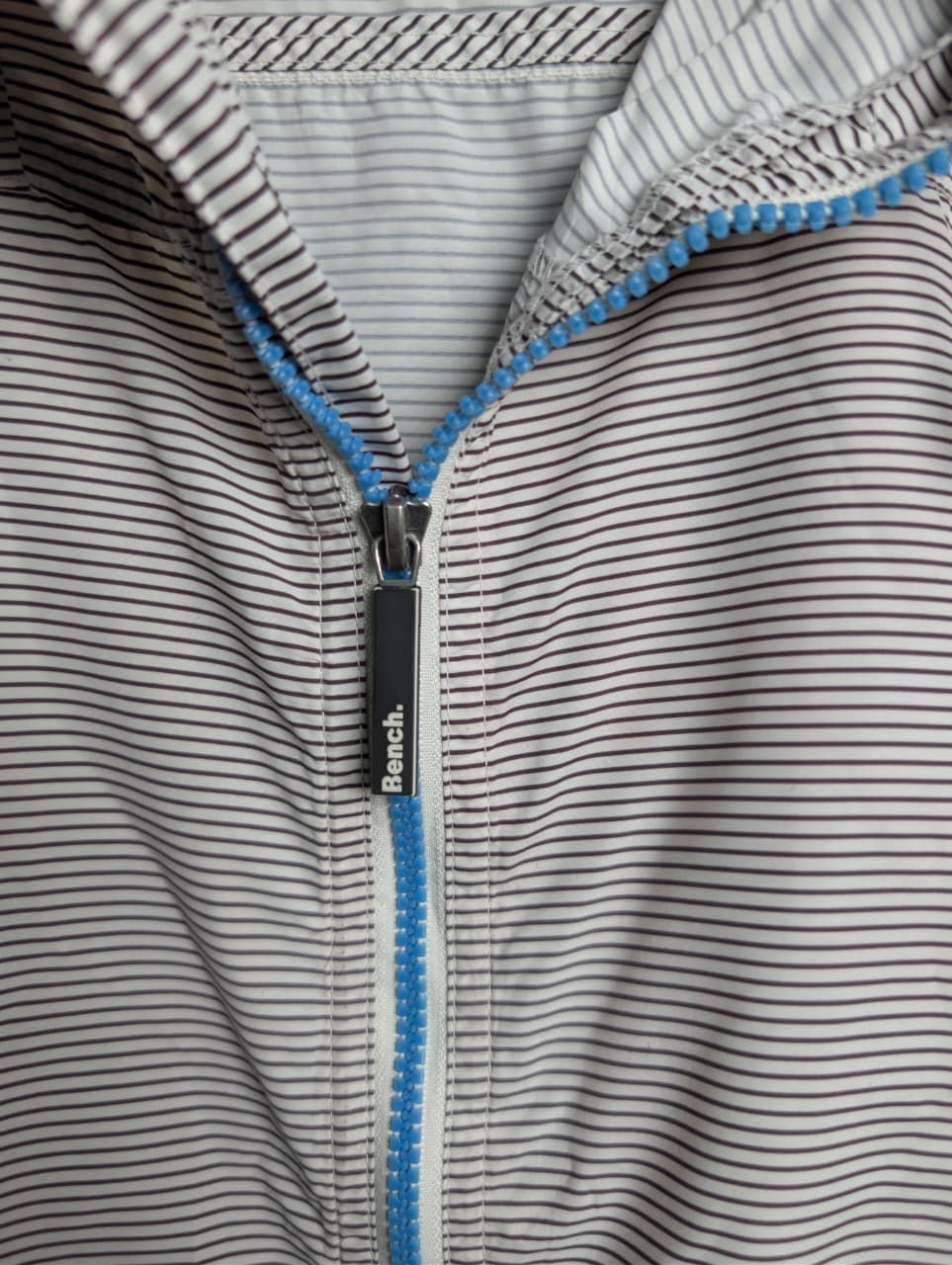 Men's Bench lightweight hooded windbreaker jacket with blue accents.