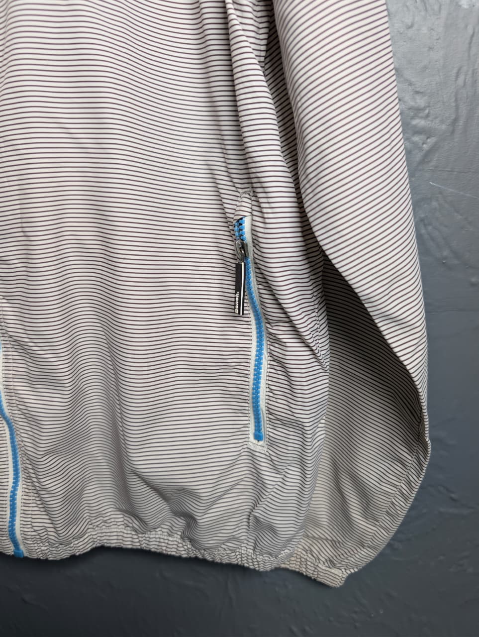 Men's Bench lightweight hooded windbreaker jacket with blue accents.
