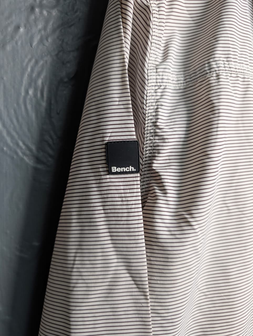 Men's Bench lightweight hooded windbreaker jacket with blue accents.