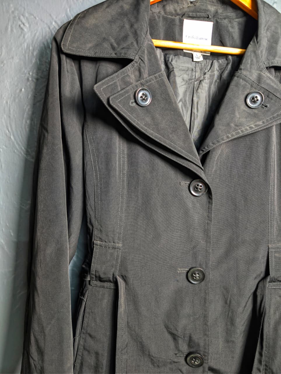 Women's jet black trench coat with a single-breasted design with a 3-button front closure