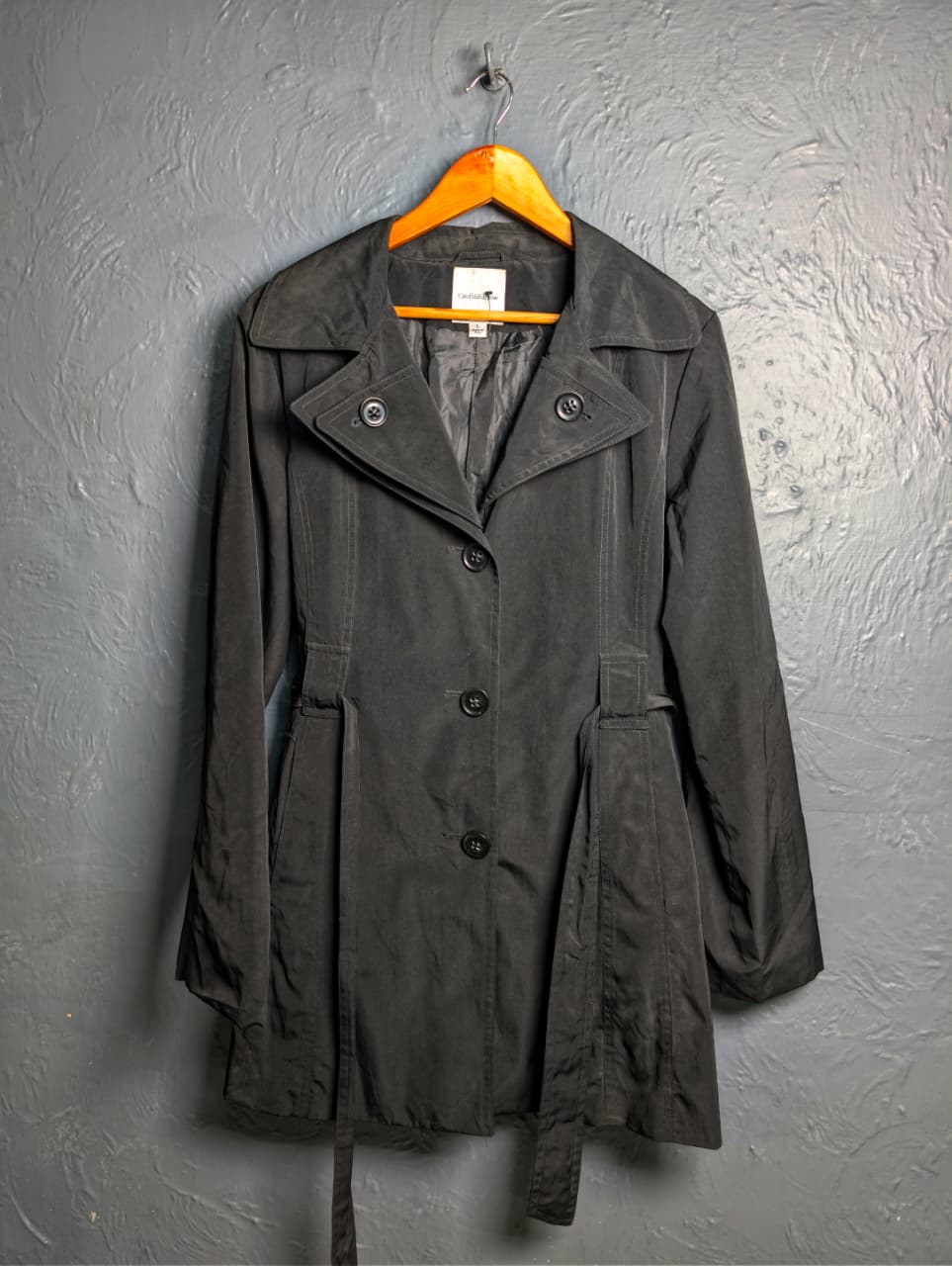 Women's jet black trench coat with a single-breasted design with a 3-button front closure