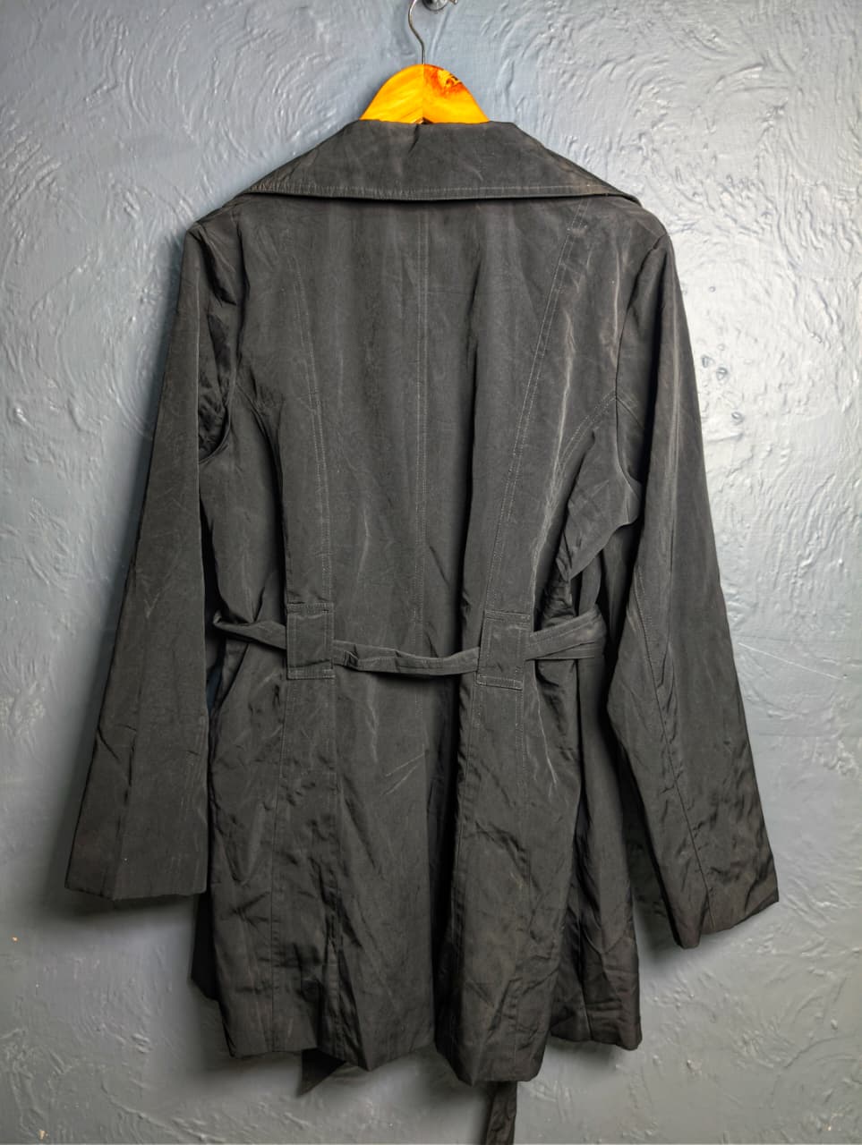 Women's jet black trench coat with a single-breasted design with a 3-button front closure