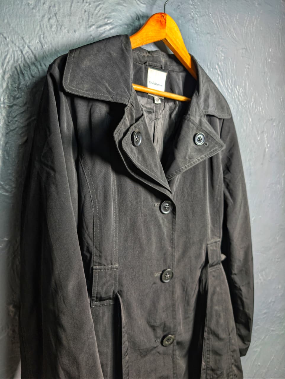 Women's jet black trench coat with a single-breasted design with a 3-button front closure