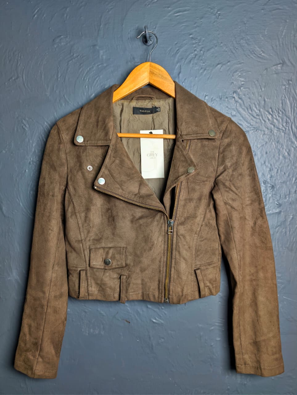 Women's cropped moto-style (biker) jacket featuring an asymmetrical zip front and notched lapels.