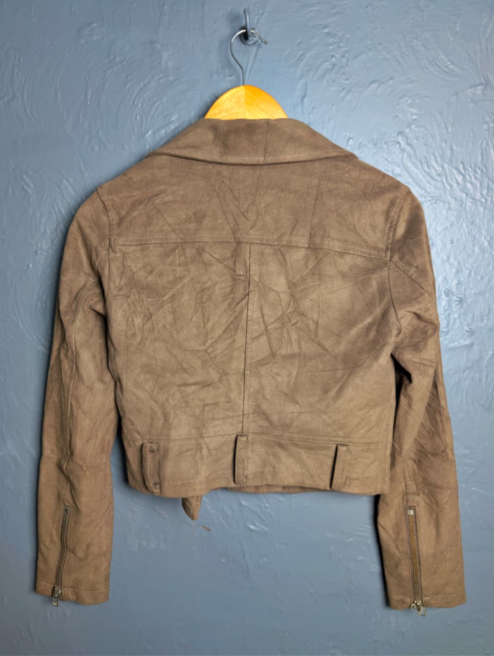 Women's cropped moto-style (biker) jacket featuring an asymmetrical zip front and notched lapels.