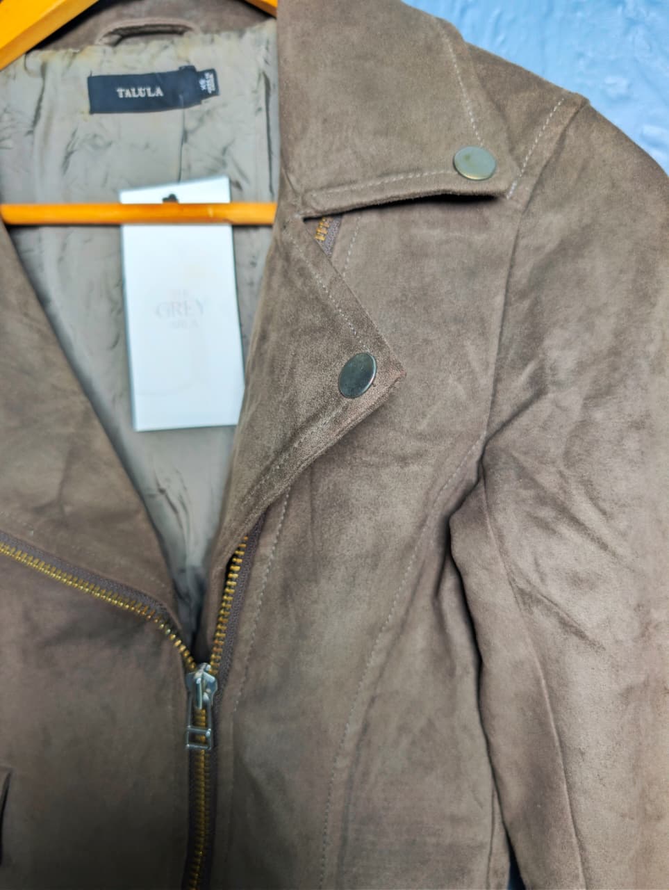 Women's cropped moto-style (biker) jacket featuring an asymmetrical zip front and notched lapels.