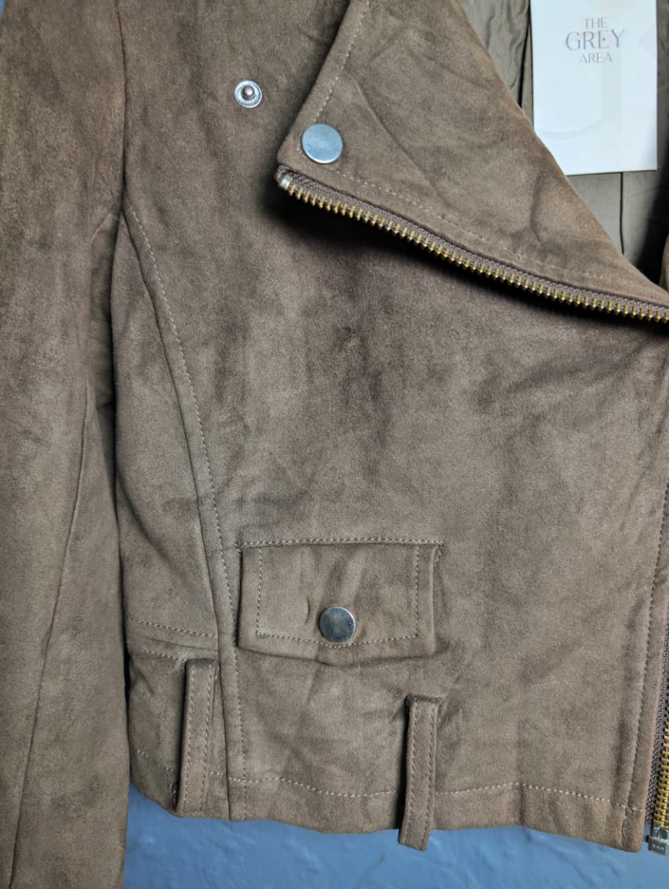 Women's cropped moto-style (biker) jacket featuring an asymmetrical zip front and notched lapels.