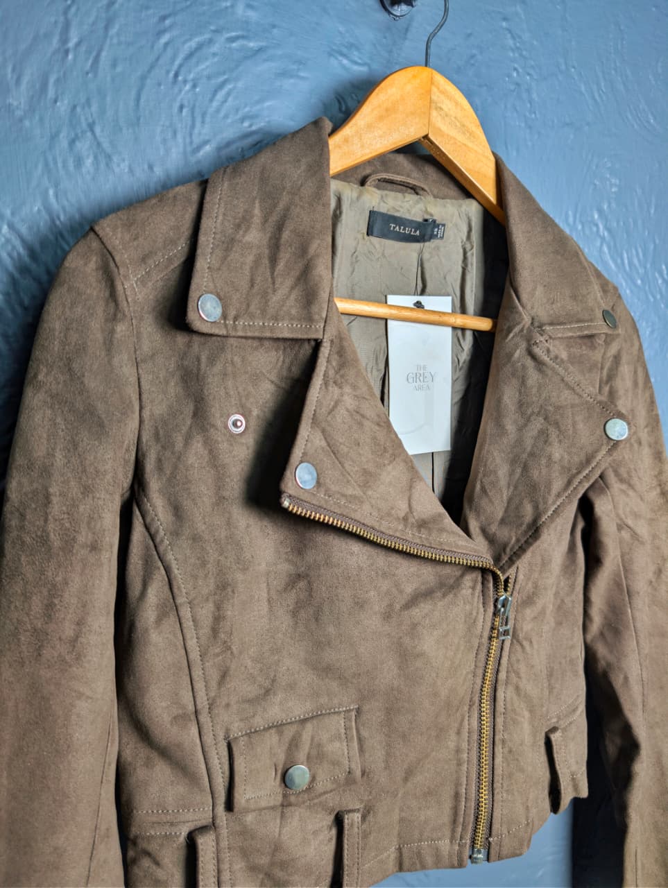 Women's cropped moto-style (biker) jacket featuring an asymmetrical zip front and notched lapels.
