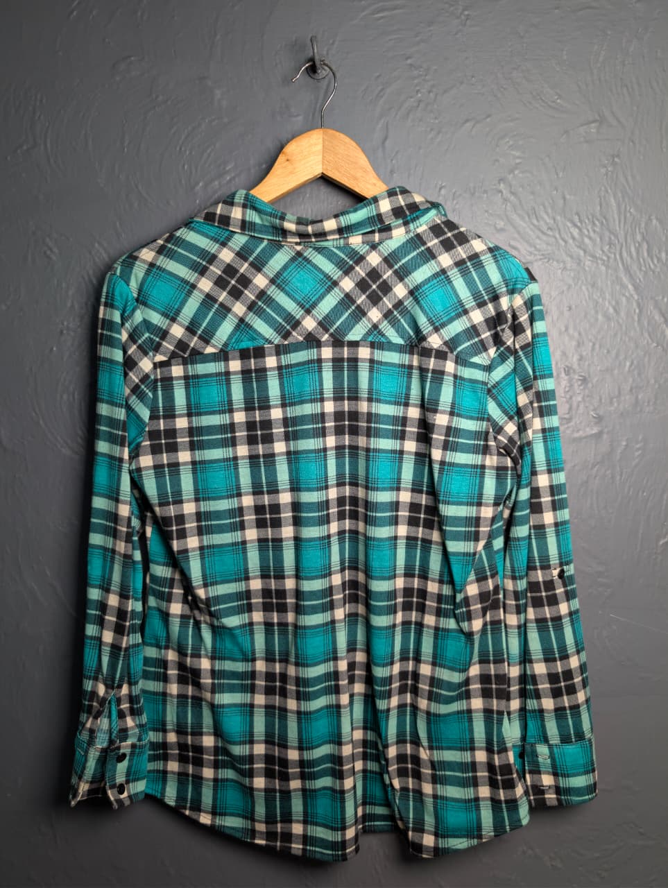 Women's turquoise and black plaid flannel shirt with chest pockets.