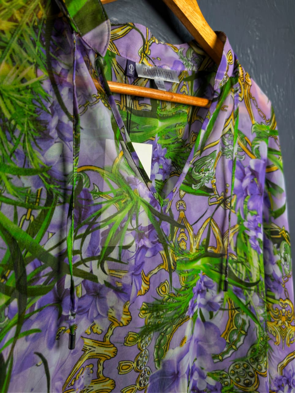 Jennifer Lopez sheer floral palm print blouse.