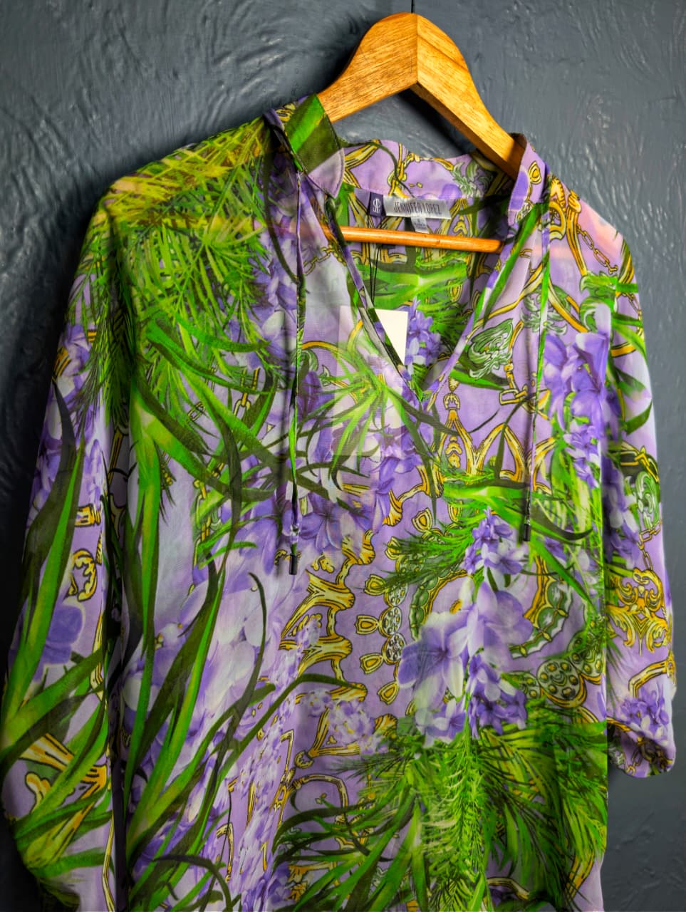 Jennifer Lopez sheer floral palm print blouse.