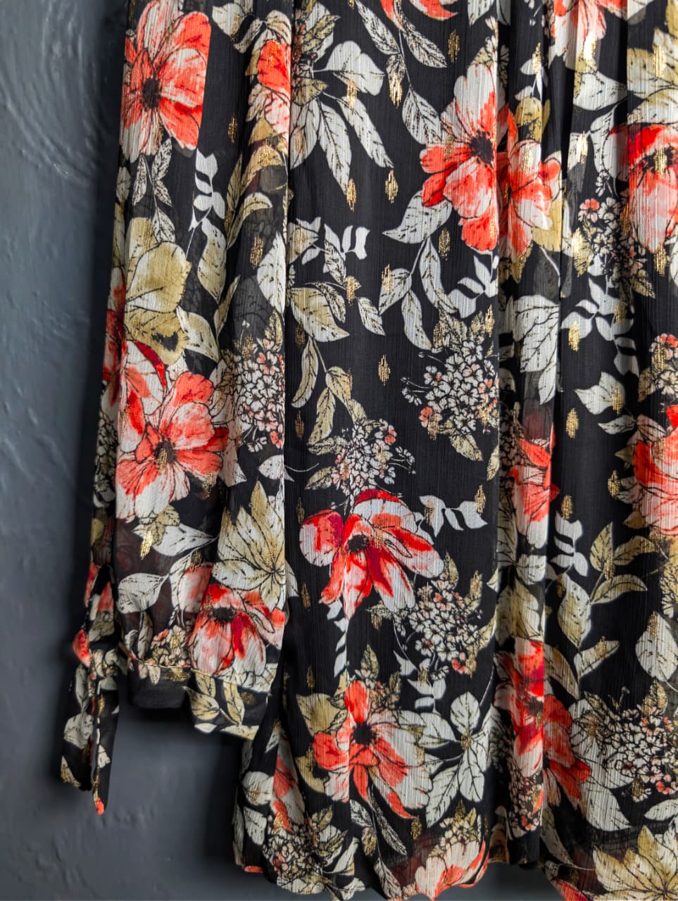 Floral blouse with 3/4 sleeves and a scoop neckline.