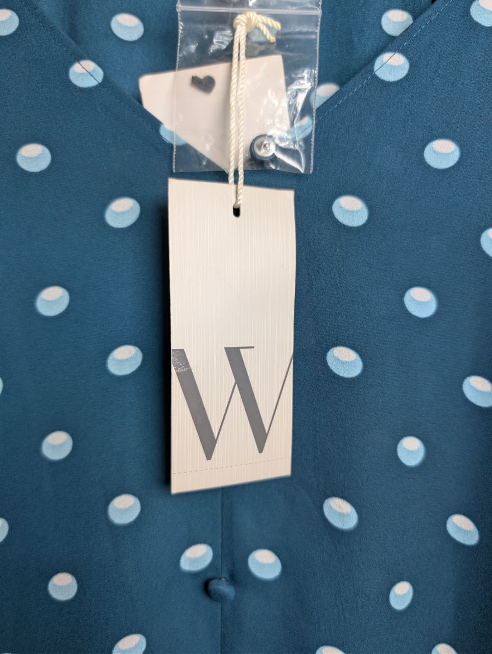 Brand New Worthington teal & polka dot top featuring short puff sleeves and a v-neckline.