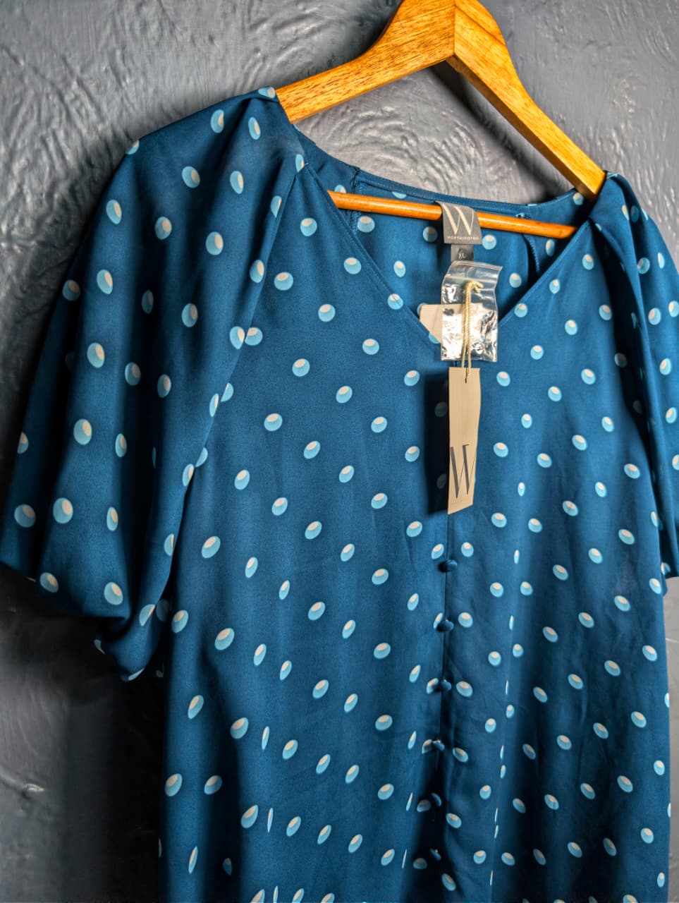 Brand New Worthington teal & polka dot top featuring short puff sleeves and a v-neckline.