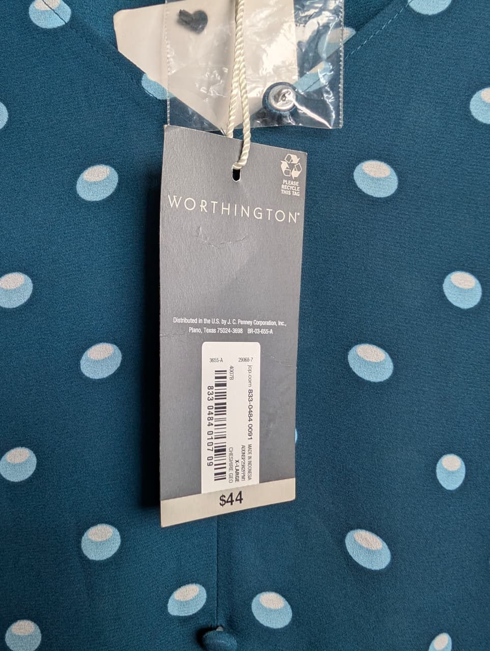 Brand New Worthington teal & polka dot top featuring short puff sleeves and a v-neckline.