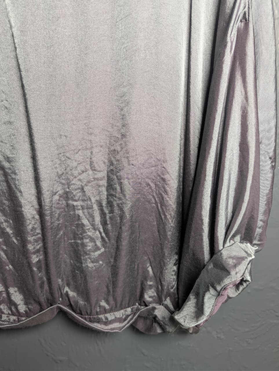 Silver satin-like top with rhinestone embellishments