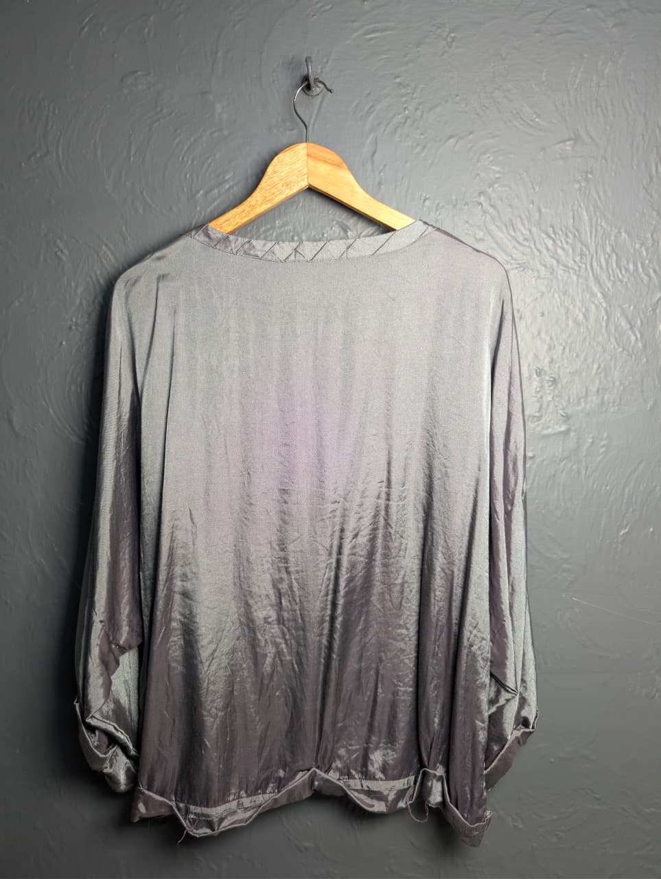 Silver satin-like top with rhinestone embellishments