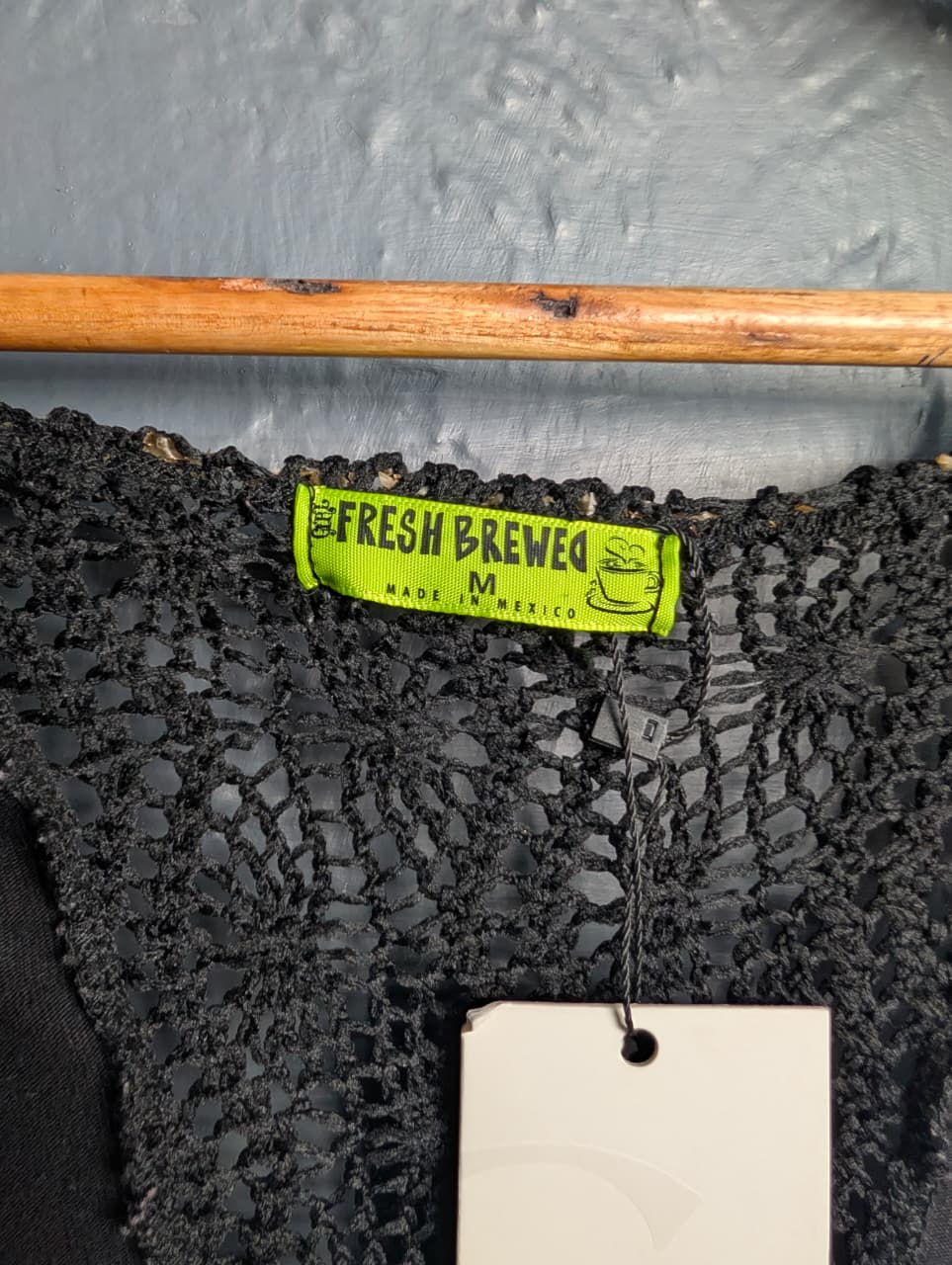 Black long-sleeve crop top with a twisted front design