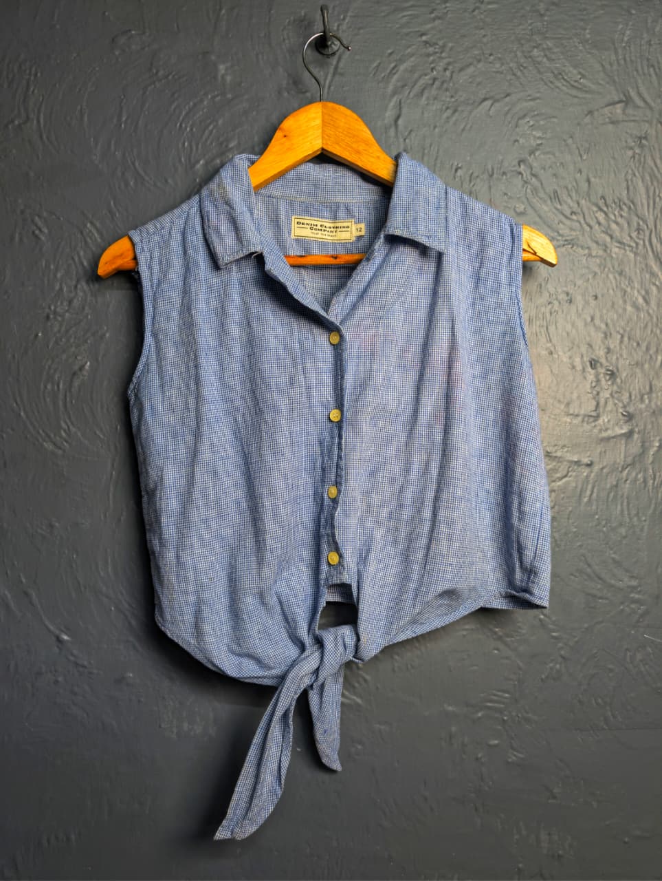 Women's sleeveless button-down top with a tie-front