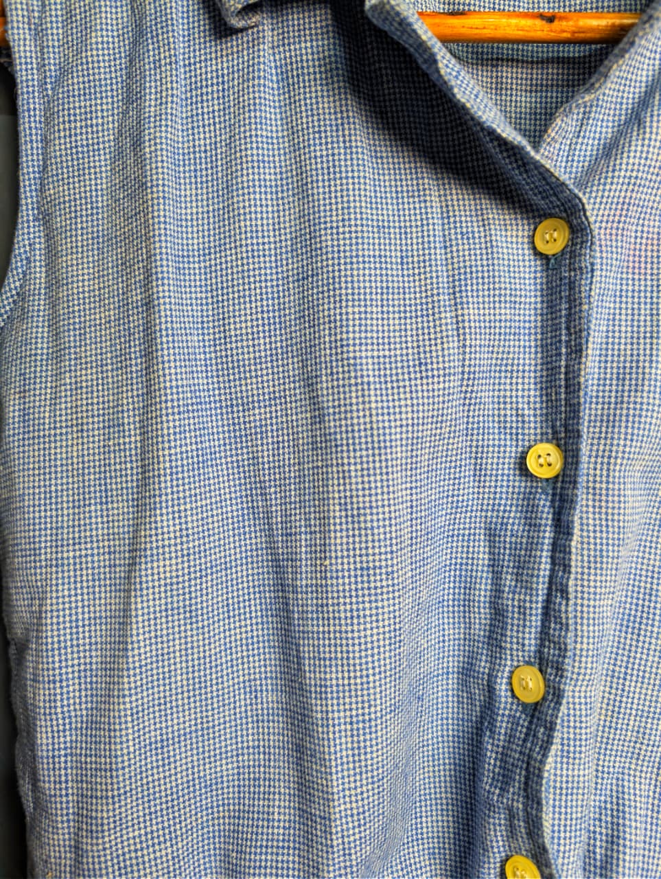 Women's sleeveless button-down top with a tie-front