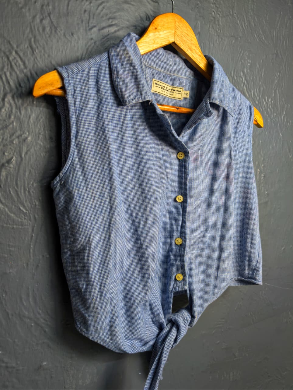 Women's sleeveless button-down top with a tie-front