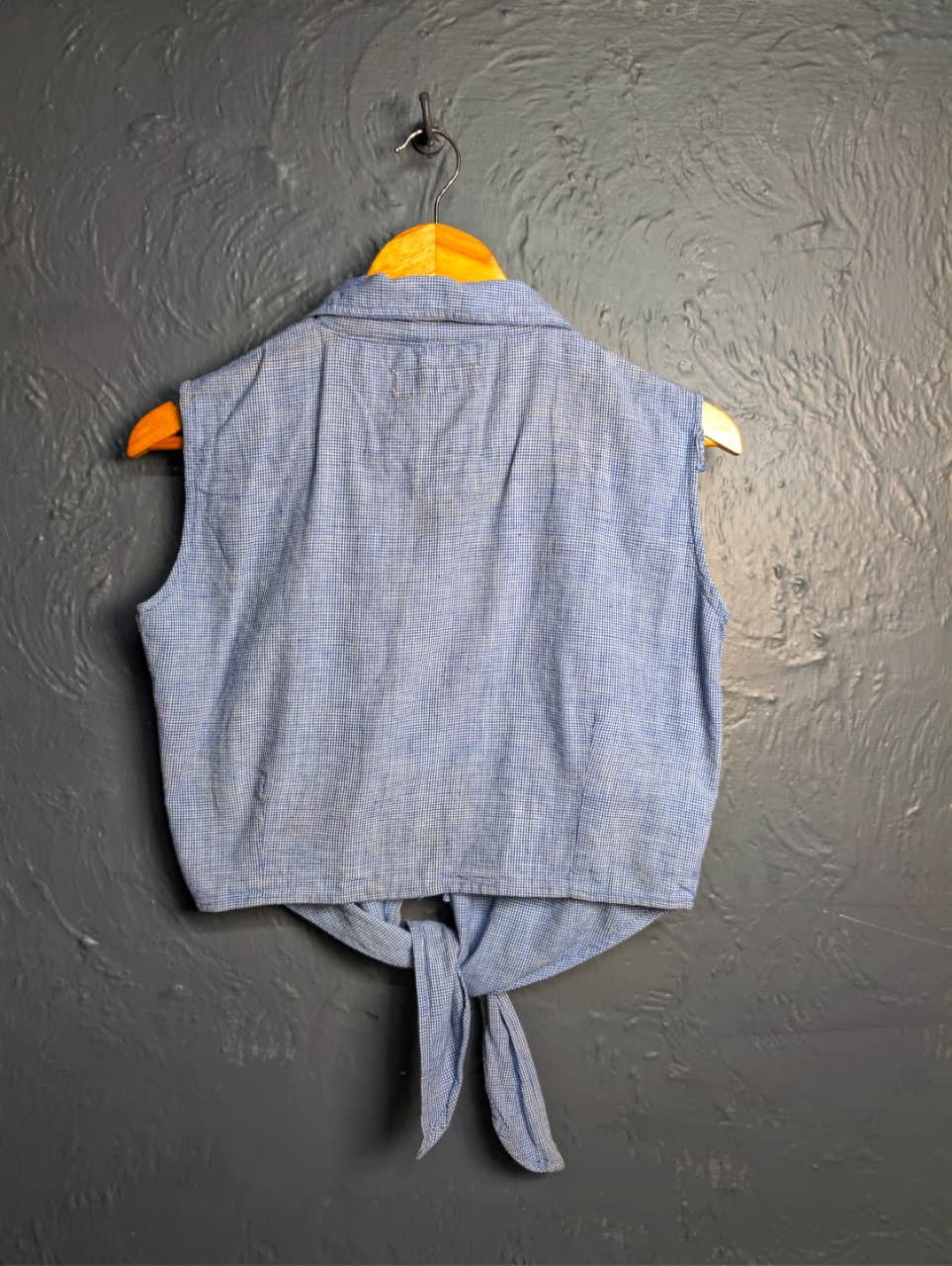 Women's sleeveless button-down top with a tie-front